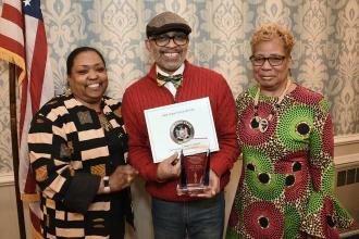 Nick Cruz, the UFT Bronx parent and community liaison shows off award.