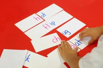 First-grader using index cards to create words.