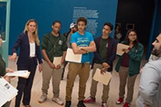 Students discuss the unusual marionettes, which are also featured in the artist’s video on the ancient roots of modern conflicts.