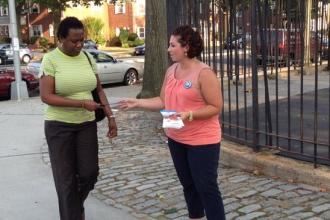 A UFT member from PS 186 hands out literature outside a polling site