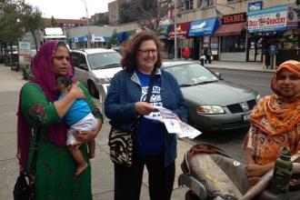 Retiree Patricia Urevith hands out literature to parents outside PS 69 