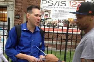 Noel Warshaw hands out leaflets to potential voters.