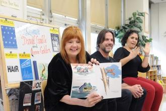 Actor Annie Golden (left) reads a book written by playwright David Caudle (middl