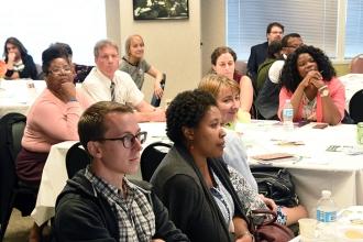 New teachers listen at the event.