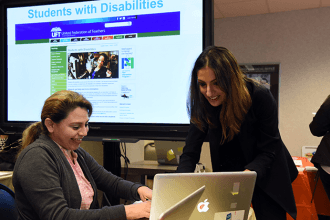 Sara Lillianfeld, a teacher at PS 24, gets some help signing up on the UFT websi
