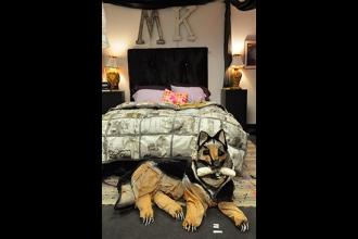 The papier-mache German shepherd at the foot of the bed actually growls at anyon
