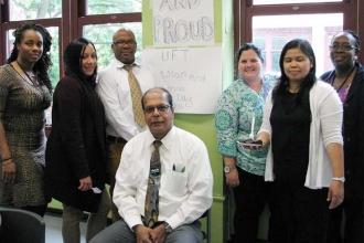 IS 292 teachers pose with Chapter Leader Chaitram Aklu (sitting) during the scho