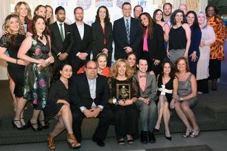 Educators from IS 61 enjoy the evening with honoree Denise Romano, a school secretary.