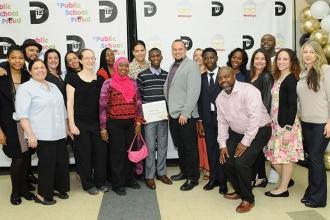 MS 129 honoree Principal Raymond Granda (center, grey jacket) is joined by schol