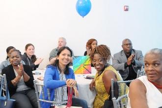 Members from PS 154 listen during introductions, including ENL teacher Marlene A
