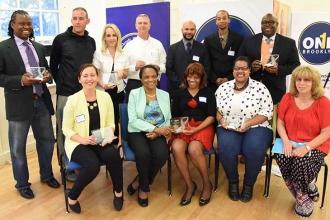 Silver award winners from schools throughout the city pose with their plaques.
