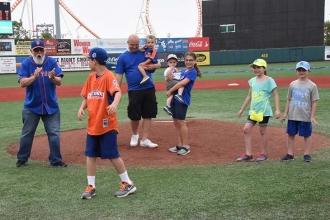 UFT Secretary Emil Pietromonaco (left) cheers after Christian’s first pitch, whi