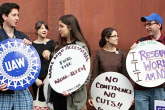 NYU graduate student employees and their supporters rally on campus last spring before delivering a petition demanding that the university restore cuts made to their health care earlier in the year.