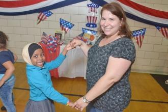 Chapter Leader Lauren Weintraub steps out with a student at the Ambassador Ball.