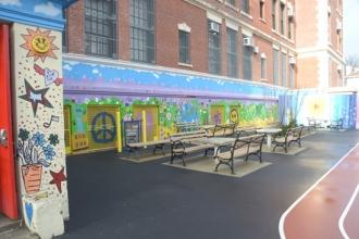 The PS 119 outdoor murals (above and at right) put a happy face on the 110-year-