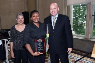Honoree Timisha Harvell, a counselor at PS 81 in Brooklyn, poses with Chapter Le