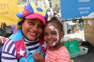 JJ the Clown gets a smile from Tamara, a student at PS 16 in Staten Island.