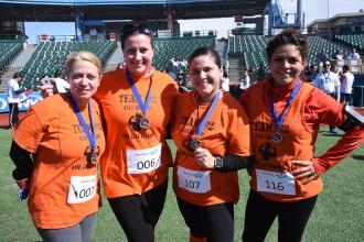 UFT members show off their medals for completing the 5K at Coney Island.