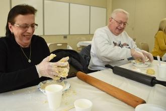 Retirees Denise and Alexander Famularo combine flour and egg for their handmade 