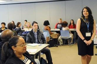 Kyri Kipriadis (standing), a guidance counselor and yoga instructor in Brooklyn,