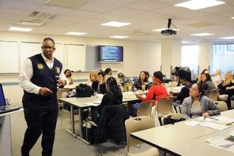 Norbert Davidson (standing) presents information during Overview of Youth Gang-R