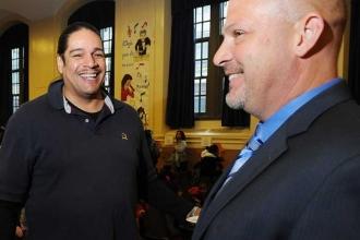 Mulgrew shares a laugh with teacher Robert Trevino after the meeting.
