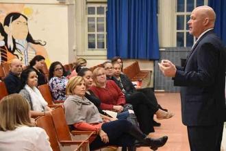 Mulgrew gives a report of national, state and local education topics while meeti