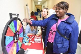 A visitor tries out the Spin to Win game at the Leukemia Society table.