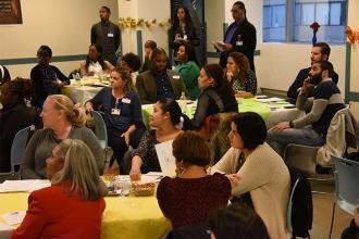 New lead teacher assistants listen to advice and network with colleagues at a me