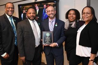 In a surprise move, BRAVE founder David Kazansky (center) was honored. Posing wi