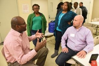 UFT Vice President Sterling Roberson (left) chats with teachers Sandy Magny (sec