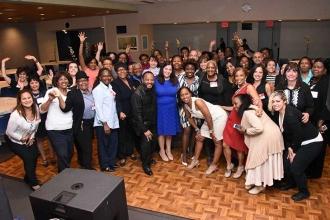 UFT Vice President Anne Goldman (in blue, center) stands beside Anthony Harmon, 
