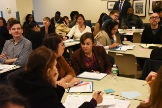 Attendees at the Socratic Seminar take time to confer.