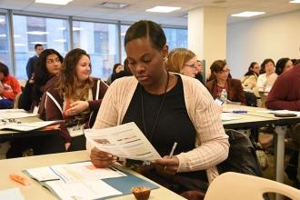 Taniqua Scott of IS 145 in Jackson Heights, Queens, studies workshop materials.