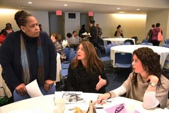 Lorraine Haynes (standing), the director for medical leaves at the New York City