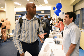 Stanley Harris (left), a teacher at PS 191, speaks with Barry Greenberg, a UFT s