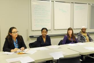 Four people behind a long table