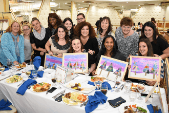 Educators from PS 316 in Ozone Park show off their artwork.