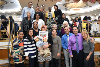 Educators from PS 273 in Richmond Hill pose with their centerpiece.