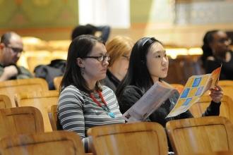 Quest to Learn/M422 teachers Harmony Olaerts (left) and Leaya Lin look over info