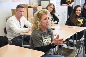 Woman seated listens intently
