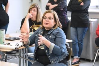 Woman seated gestures while speaking