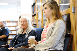 Teacher Allison Burke listens as staff members speak.