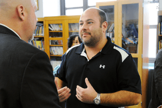 Physical education teacher Brett Rinella speaks with Mulgrew at the end of the m