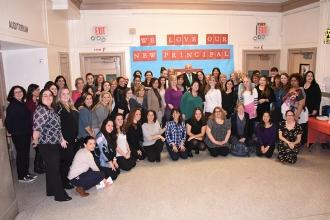 The school community gathers together under a message that spells out their shar