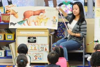 Teacher Patty Zhao leads her kindergartners through shared reading at PS 134.