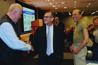 RTC members chat with Ost (center) after his presentation.