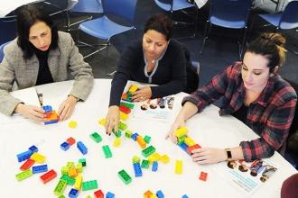 Participants work on a project with Duplo bricks during the Early Childhood LEGO