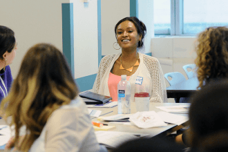 Teachers share their experiences in a workshop during New Teacher Week.