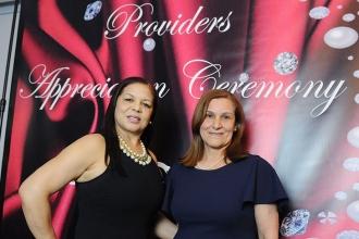Caridad Garcia (left) and Mariluz Madera, providers from the Bronx, take a shot 